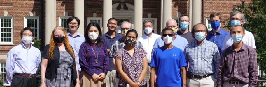 Computer Science Faculty and Staff wearing masks in front of the Petty Building Bridge